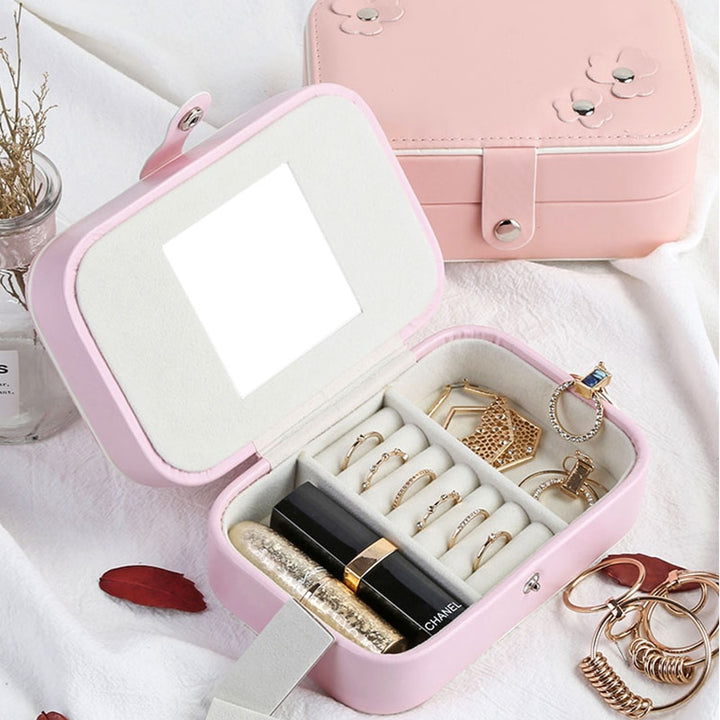 Close-up of the second storage layer, featuring compartments for rings, necklaces, and small jewelry pieces, with a soft velvet lining.