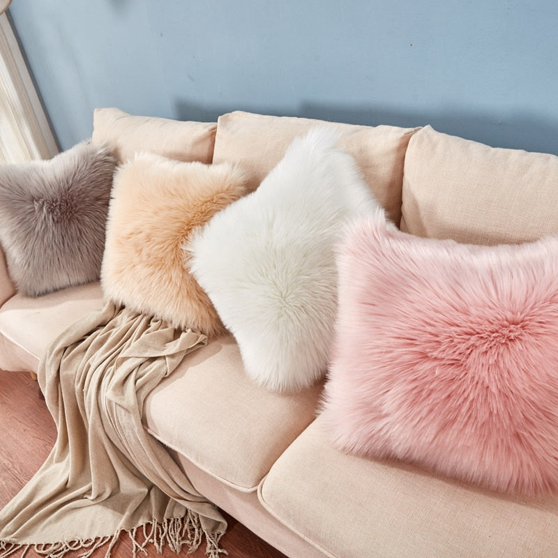 VibeCore Fluffy Faux Fur Pillow Case in 4 colors displayed on a couch, showcasing its luxurious texture and cozy, spunky design.