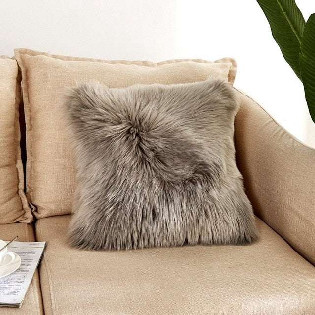 VibeCore Fluffy Faux Fur Pillow Case in dark gray, featuring a soft, plush texture on a cozy couch.