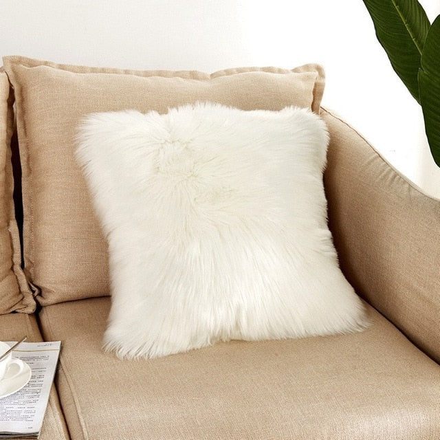 VibeCore Fluffy Faux Fur Pillow Case in white, featuring a soft, plush texture placed on a cozy couch.