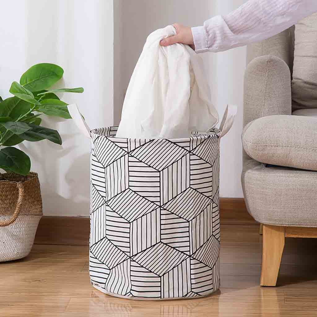 VibeCore Foldable Abstract Laundry Basket with laundry being taken out, featuring a large-capacity, waterproof, and dustproof design with reinforced handles for easy carrying.