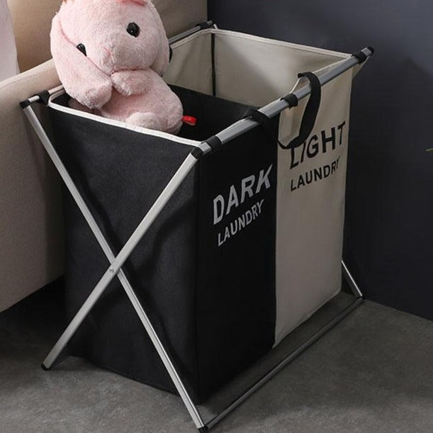 VibeCore Foldable Laundry Basket Organizer by couch, showcasing a space-saving, waterproof design with reinforced handles for easy carrying and laundry sorting.
