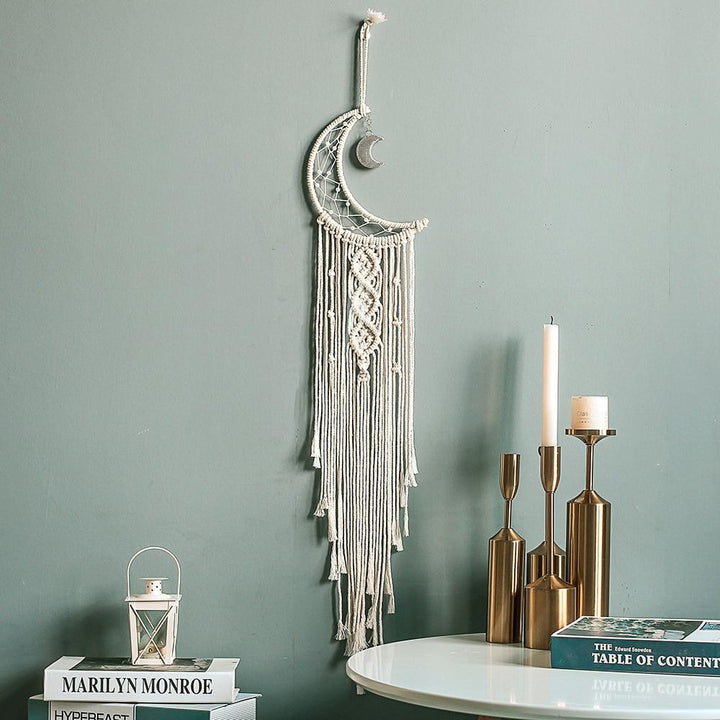 VibeCore Handmade Macrame Moon Wall Hanging on the living room wall, adding a magical, celestial touch to the space with its intricate cotton thread design.