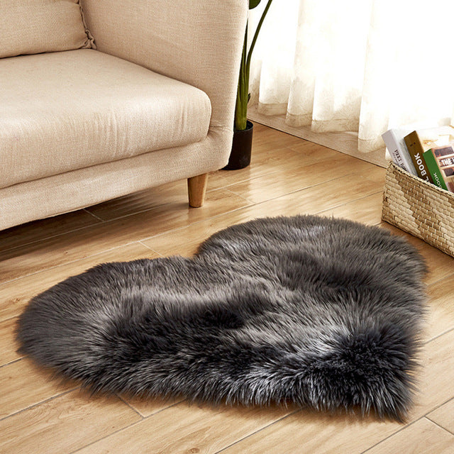 VibeCore Heart-Shaped Accent Rug in dark gray, made with plush faux sheepskin for a luxurious feel, featuring a non-slip backing to keep it securely in place, perfect for adding comfort and style to any room.
