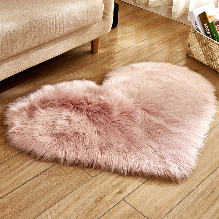 VibeCore Heart-Shaped Accent Rug in light pink, featuring a plush, faux sheepskin texture with a cozy, non-slip design, perfect for bedrooms, dorms, or living spaces.