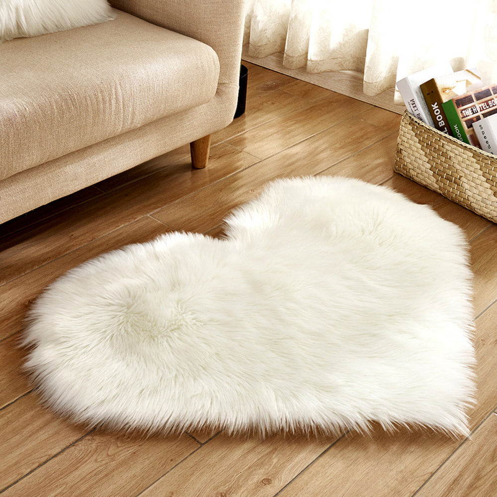 Alt Text: VibeCore Heart-Shaped Accent Rug in white, featuring a plush faux sheepskin texture with a non-slip backing, perfect for adding a cozy touch to bedrooms, dorms, or living spaces.