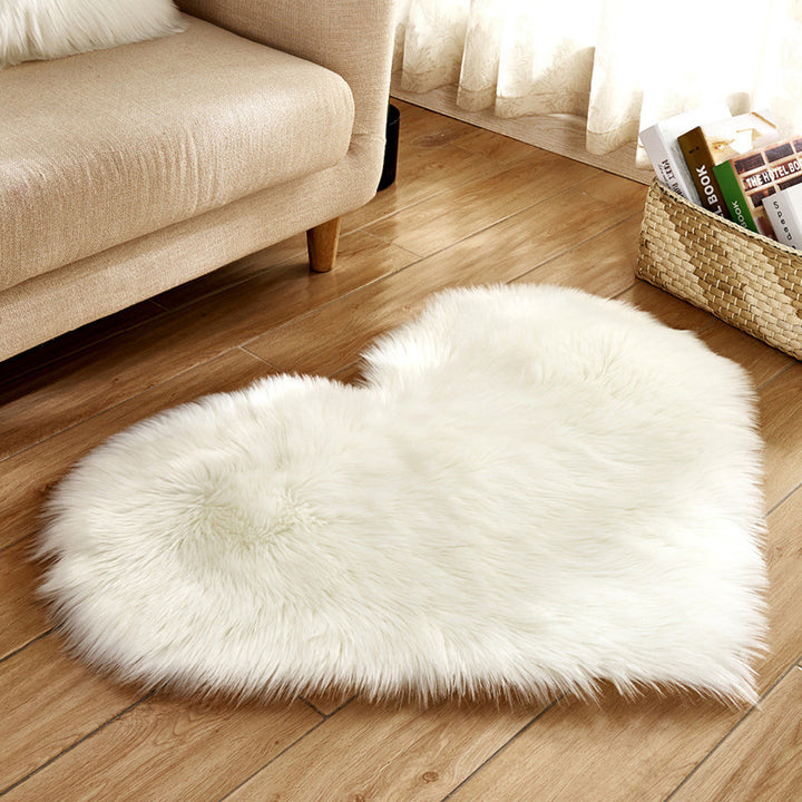 Alt Text: VibeCore Heart-Shaped Accent Rug in white, featuring a plush faux sheepskin texture with a non-slip backing, perfect for adding a cozy touch to bedrooms, dorms, or living spaces.