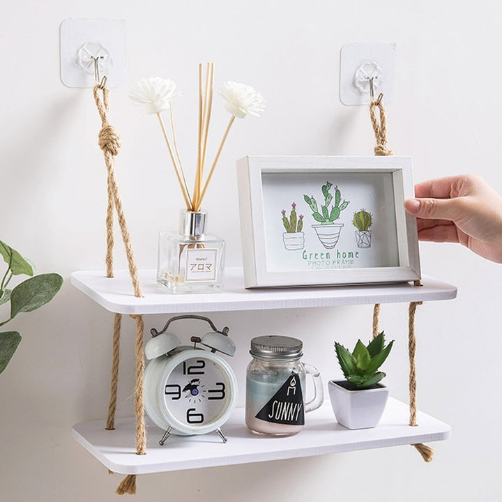 VibeCore Levelled Rope Hanging Shelf with 2 shelves, holding decor, showcasing its boho rustic design made of hemp rope and wood-plastic, perfect for organizing and displaying items.