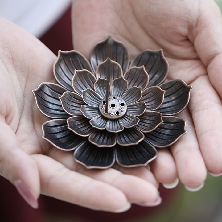 VibeCore Lotus Incense Holder being held, showing the 3-layer lotus design and the removable middle leaf layer for easy cleaning.