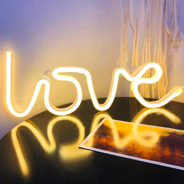 Aesthetic VibeCore Love Neon Light in warm white on a table, USB or battery-powered LED sign for trendy bedroom, dorm, or lounge decor, creating a warm, romantic glow to elevate your space.
