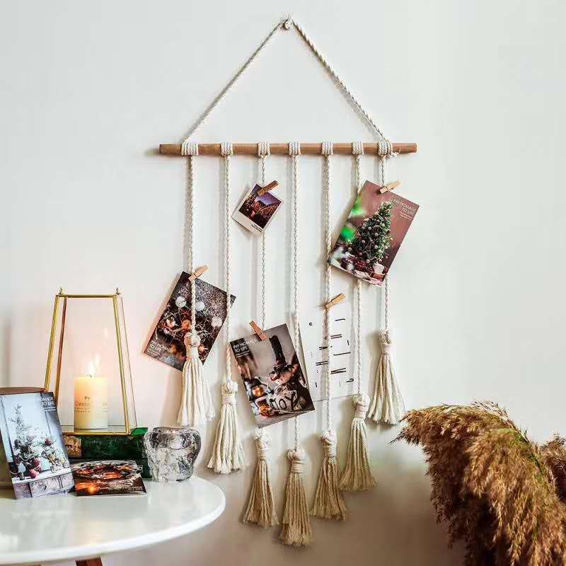 VibeCore Macrame Photo Wall Hanging Display on wall, showcasing 30 wooden clips for photos, postcards, and prints, with a boho-inspired design, perfect for personalized room decor.