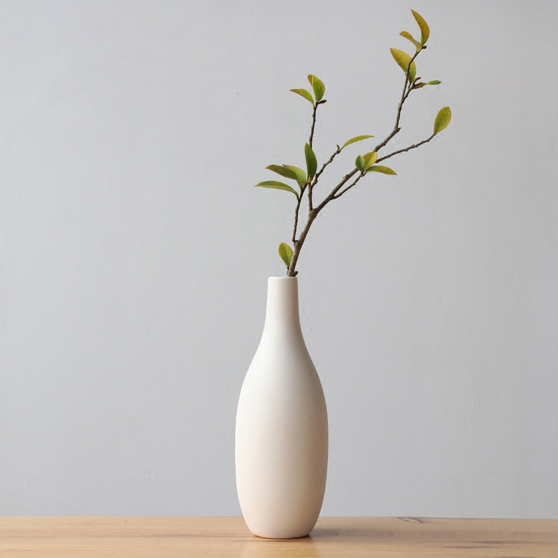 VibeCore Matte White Ceramic Flower Vase, featuring a minimalist tube design, perfect for showcasing fresh flowers, adding a modern touch to home décor in bedrooms, offices, or apartments.