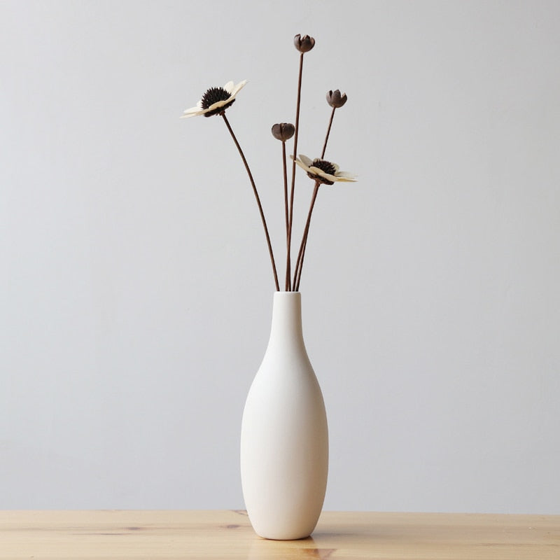 VibeCore Matte White Ceramic Flower Vase with fake flowers, featuring a minimalist tube design, perfect for adding a modern touch and enhancing any room decor with faux floral arrangements.