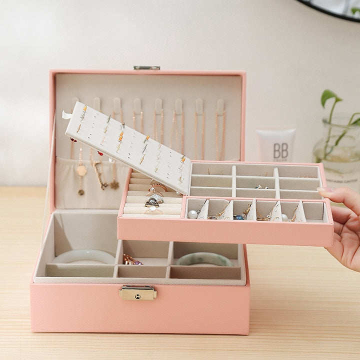 VibeCore Multi-Layer Jewelry Box in Blossom with Removable Layer – sleek, lockable design featuring two layers and a bonus top storage component. The removable layer provides flexible organization for rings, necklaces, and earrings. Ideal for travel, everyday use, and as a thoughtful gift for any occasion.