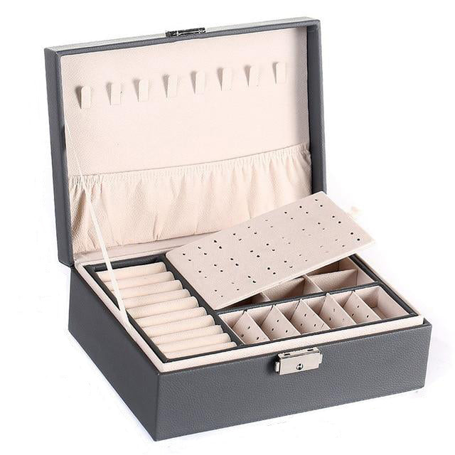VibeCore Multi-Layer Jewelry Box in Gray – sleek, lockable design with two layers and bonus top storage. Ample space for organizing rings, necklaces, and earrings. Perfect for travel, everyday use, and a thoughtful gift for any occasion.