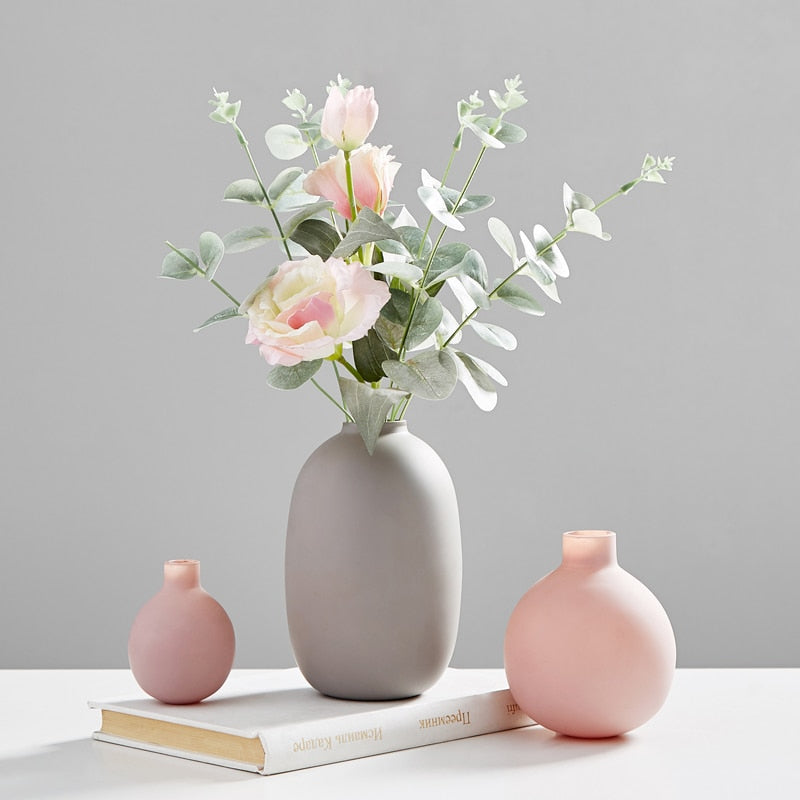 VibeCore Nordic Ceramic Vases in gray with flowers, alongside pink and mini pink vases, styled together as modern minimalist home decor.