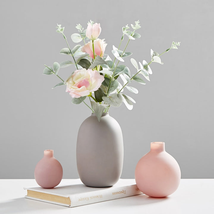 VibeCore Nordic Ceramic Vases in gray with flowers, alongside pink and mini pink vases, styled together as modern minimalist home decor.