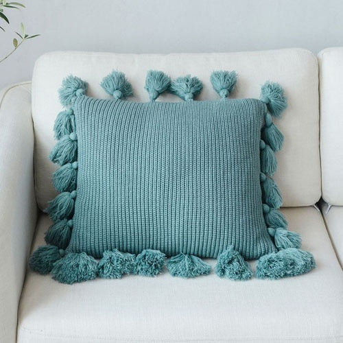 VibeCore Nordic Style Hand-Knitted Pillow Cover in Turquoise Blue with fringe details, adding a vibrant boho touch to a modern living space.
