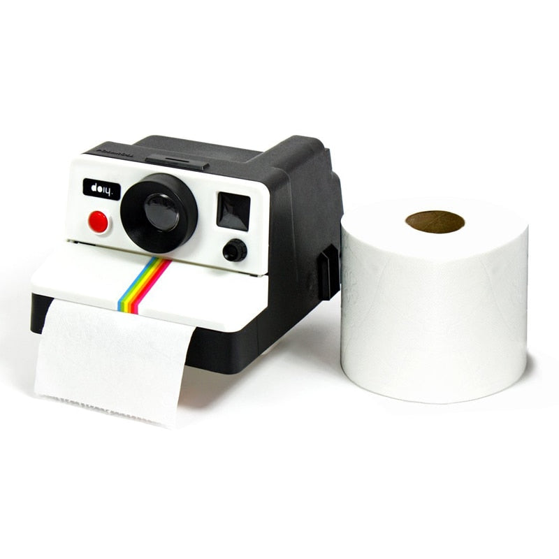 VibeCore Polaroid Toilet Paper Holder next to toilet paper, showcasing its retro Polaroid camera-inspired design and functionality.