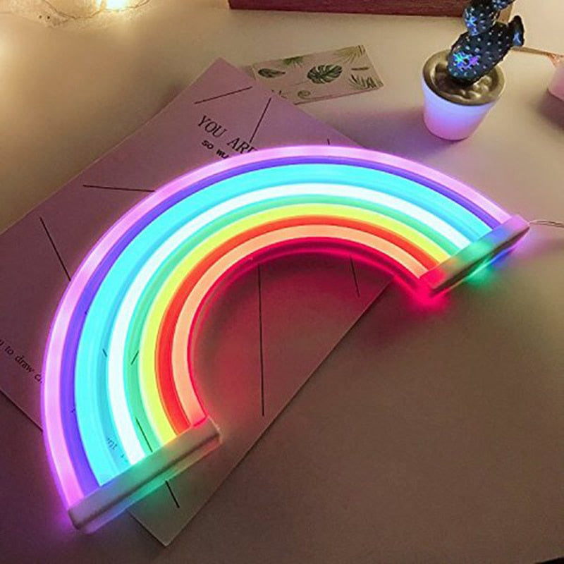 VibeCore Rainbow Neon Light placed on a table, showcasing its vibrant glow and colorful LED design. Perfect for adding a playful and uplifting touch to any space.