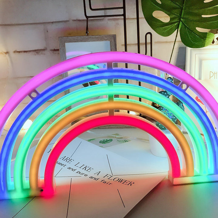 VibeCore Rainbow Neon Light standing upright on a table, displaying its bright and colorful LED glow. A fun and eye-catching decor piece for any space.