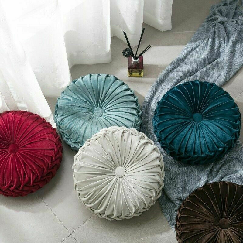 VibeCore Round Velvet Cushions in multiple colors, arranged on the floor from an alternative angle, highlighting their soft, plush texture and elegant appearance.