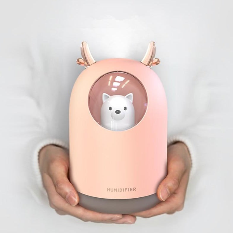 VibeCore Space Dog Humidifier Blossom being held, showcasing its cute design and compact size, perfect for adding a colorful and refreshing touch to any space with essential oil compatibility.