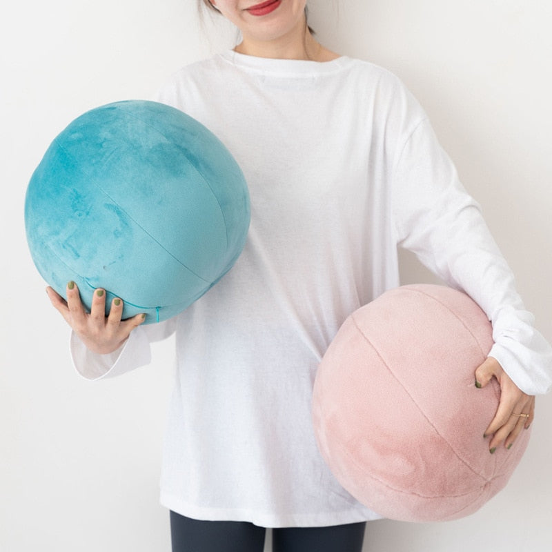 VibeCore Velvet Ball Pillows in mauve and yellow, girl holding two plush round velvet pillows, cozy and stylish decor for modern bedroom or lounge space.